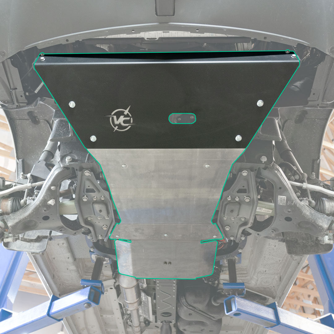 Close-up of a car's hood featuring a metal plate and logo on a black surface.