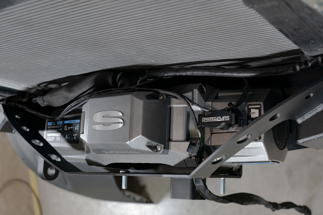 Close-up of the FRONT WINCH MOUNT WITH BULL BAR - SPRINTER (2019+) by VAN COMPASS, highlighting its robust design and integrated features for enhanced utility and safety.