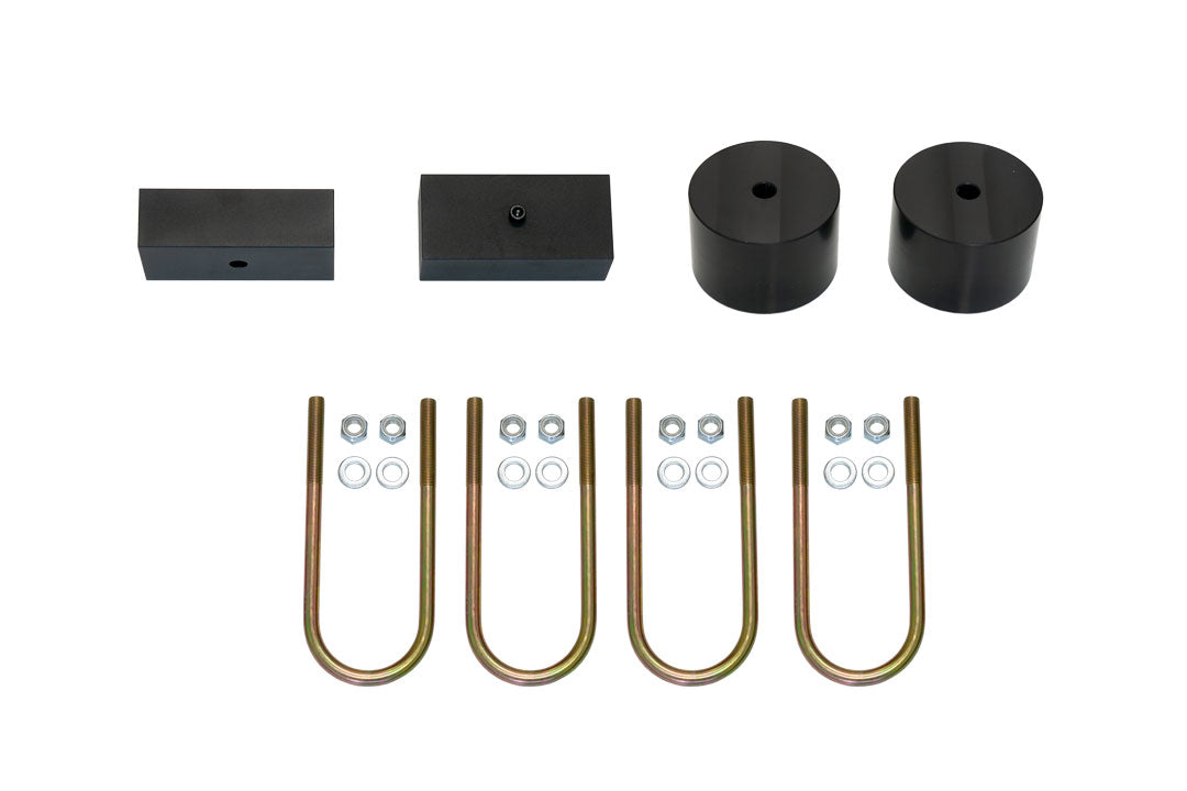 TOPO 2.0 Front and Rear Lift Kit - Transit (2015-Present, Single or Dual Rear Wheel) by Van Compass, showing metal parts, nuts, bolts, and a black cylinder.