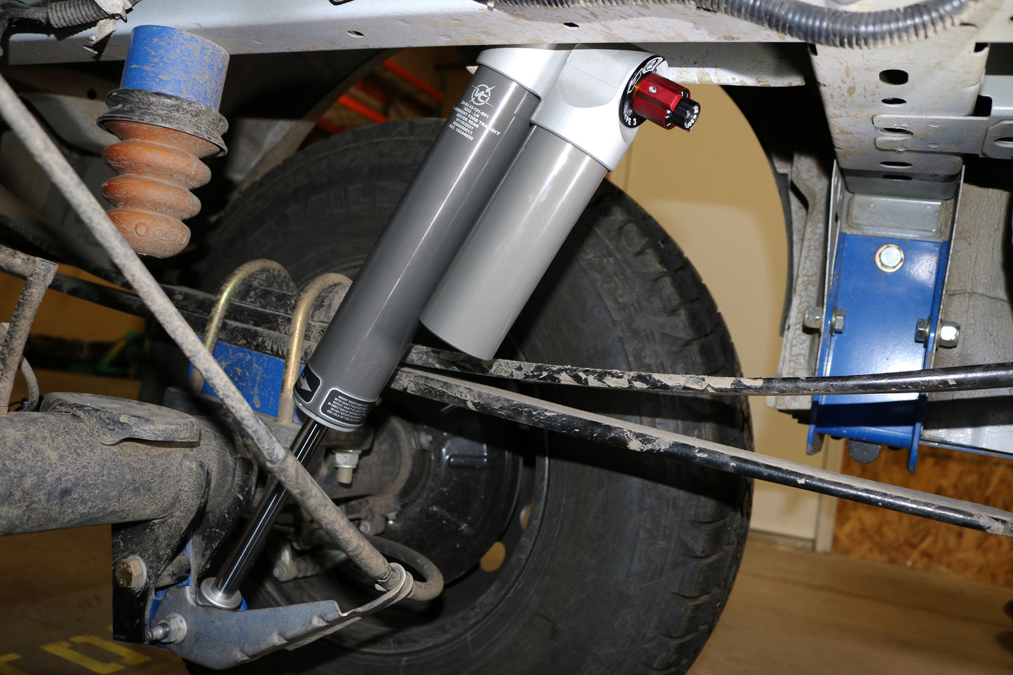 Close-up of Falcon 3.3 SP2 Fast Adjust Rear Shocks for 2013+ Transit, focusing on the suspension and adjustment knob, showcasing precision engineering and performance features.