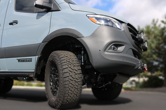 BIG TIRE MUDFLAP RELOCATION KIT - SPRINTER (2019+) by VAN COMPASS installed on a van, showcasing close-up views of tires, wheel openings, and fender modifications.