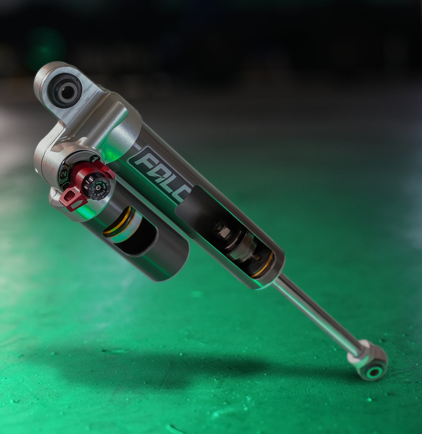 Close-up of a silver machine component featuring black cylindrical pipes and intricate mechanical parts.