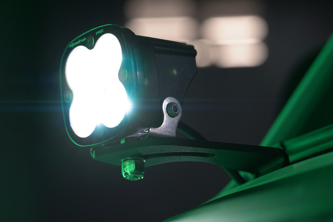 HOODLINE LIGHT POD MOUNT - SPRINTER (2019+) by VAN COMPASS: Close-up of a van's hood, showcasing easily installed LED pod mounts attached to the factory hood hinge studs.