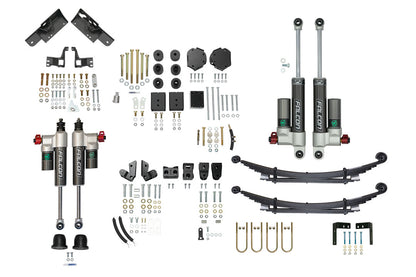 STAGE 6.3 DUALLY 2 LIFT SYSTEM - SPRINTER AWD (2023+ 3500) by VAN COMPASS: Close-up of vehicle parts, including adjustable shocks, springs, and brackets for enhanced suspension and ground clearance.