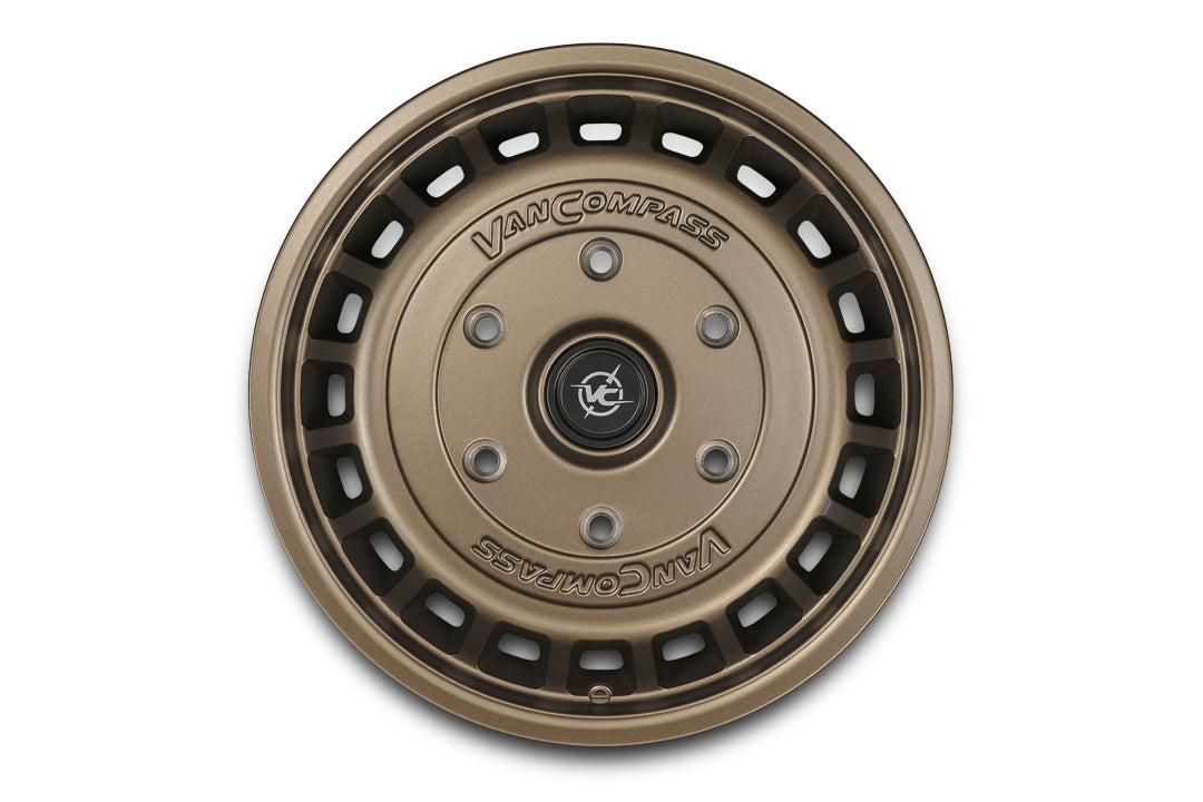 A bronze-colored multi-spoke wheel rim with 'Van Compass' branding on the center cap, shown against a plain white background.