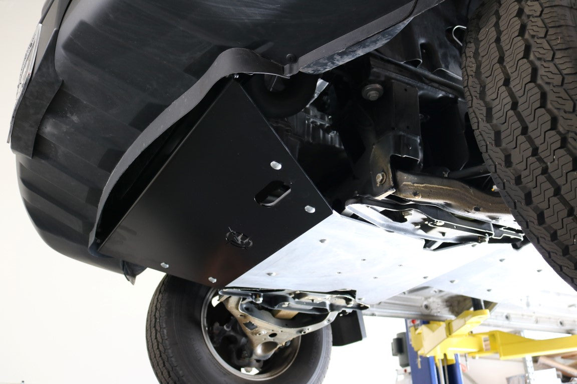 ENGINE SKID PLATE - SPRINTER 4X4 (2015-2022 2500 OR 3500) by VAN COMPASS, close-up of tire tread and undercarriage, showcasing protective components.