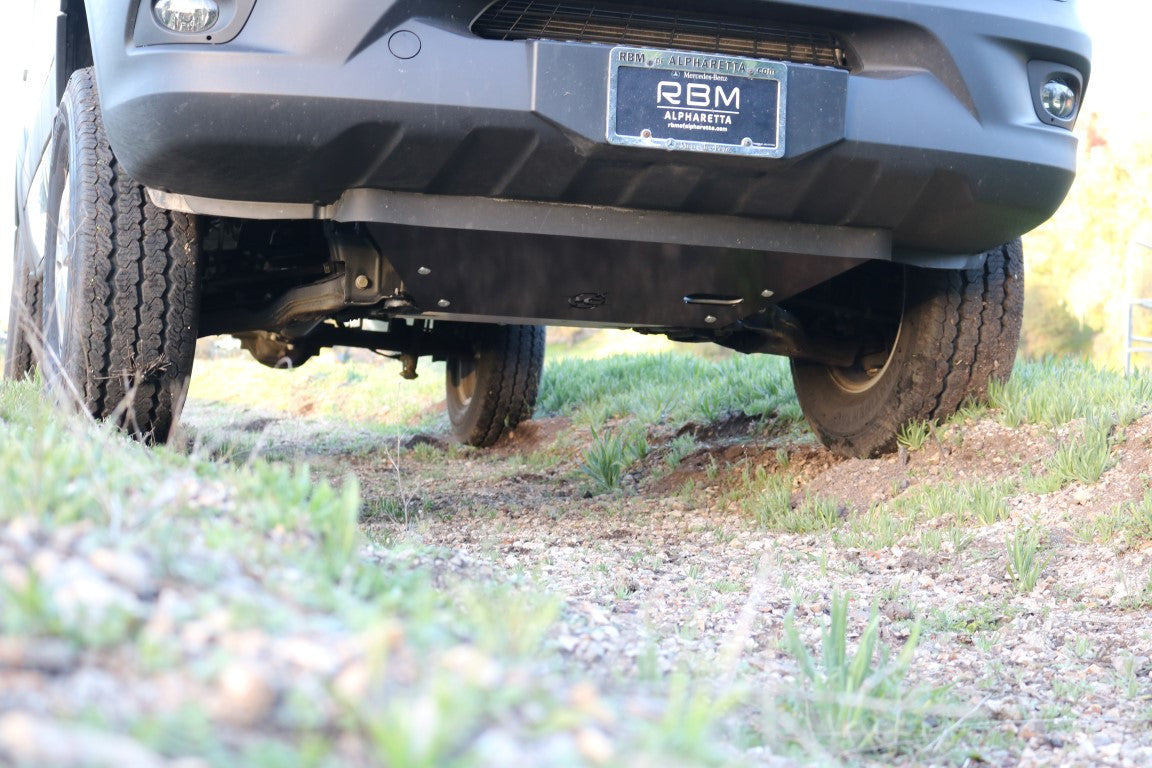 ENGINE SKID PLATE - SPRINTER 4X4 (2015-2022 2500 OR 3500) by VAN COMPASS, close-up of installed skid plate protecting the vehicle's drivetrain components.