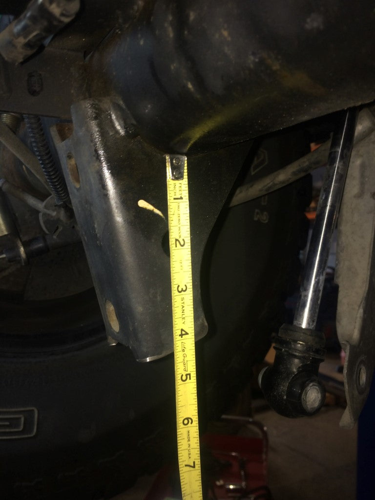 Rear High Clearance Shock Extension Brackets for Transit (2013+) by Van Compass, shown mounted on a vehicle, enhancing under axle ground clearance and shock protection.