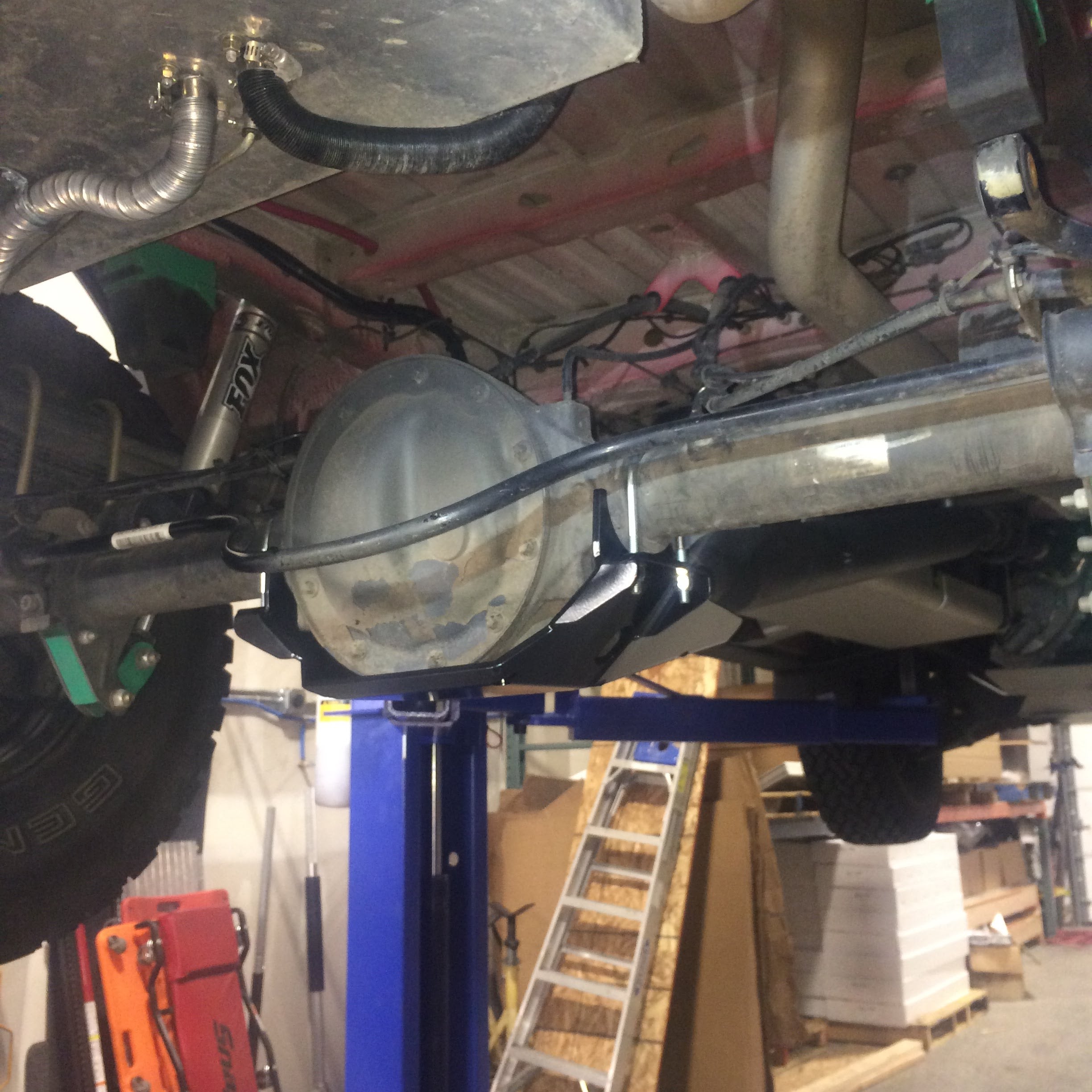 Differential skid plate for 2015+ Sprinter 2500 by Van Compass, shown protecting a vehicle's rear differential with a 1/4 steel, black powder-coated plate.